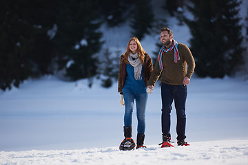 Image showing couple having fun and walking in snow shoes