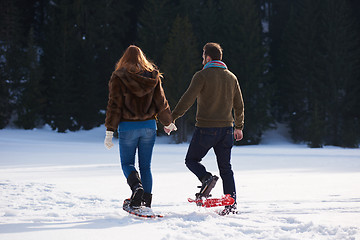 Image showing couple having fun and walking in snow shoes