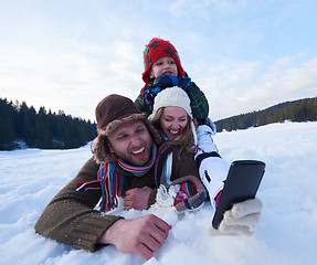 Image showing romantic couple have fun in fresh snow and taking selfie