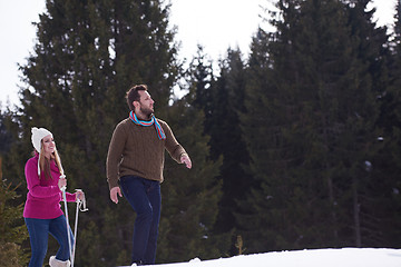 Image showing couple having fun and walking in snow shoes