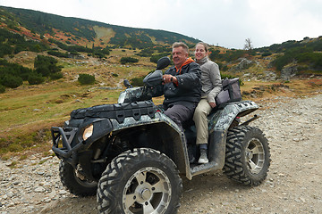 Image showing couple drive atv quad bike