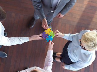 Image showing business people group assembling jigsaw puzzle