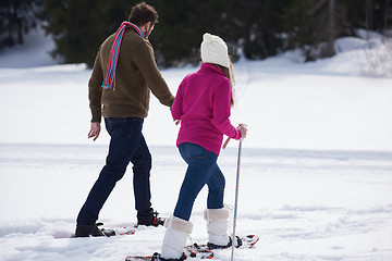 Image showing couple having fun and walking in snow shoes