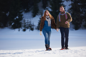 Image showing couple having fun and walking in snow shoes