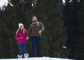 Image showing couple having fun and walking in snow shoes