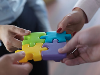 Image showing business people group assembling jigsaw puzzle