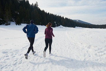 Image showing couple jogging outside on snow