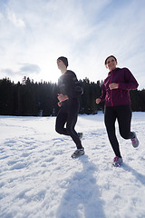 Image showing couple jogging outside on snow