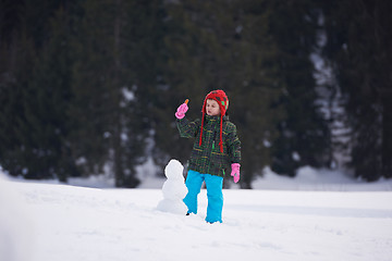 Image showing boy making snowman