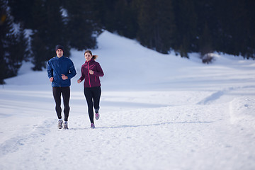 Image showing couple jogging outside on snow