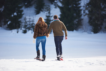 Image showing couple having fun and walking in snow shoes