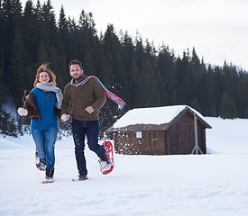 Image showing couple having fun and walking in snow shoes