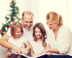 Image showing happy family with book at home