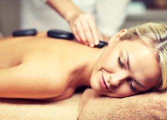 Image showing close up of woman having hot stone massage in spa