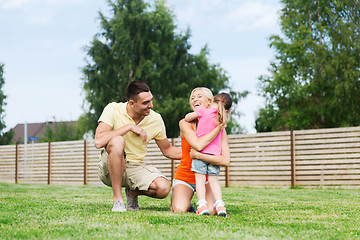 Image showing happy family hugging outdoors