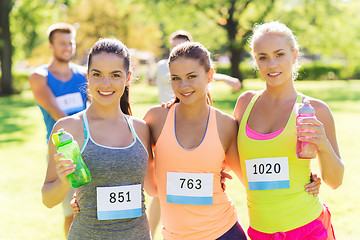 Image showing women with racing badge numbers and water bottles