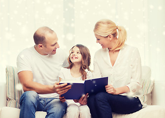 Image showing happy family with book at home