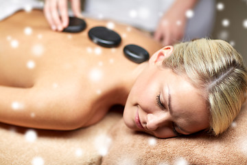 Image showing close up of woman having hot stone massage in spa