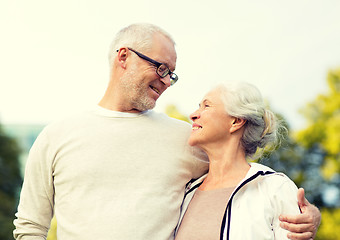 Image showing senior couple hugging in city park