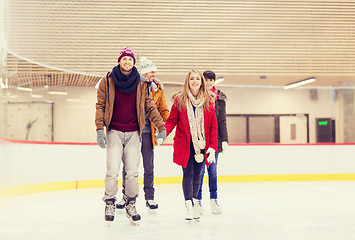 Image showing happy friends on skating rink