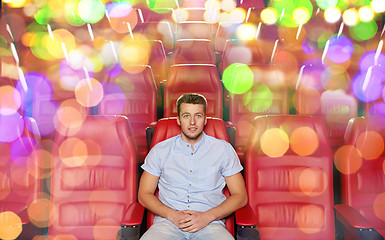 Image showing happy young man watching movie in theater