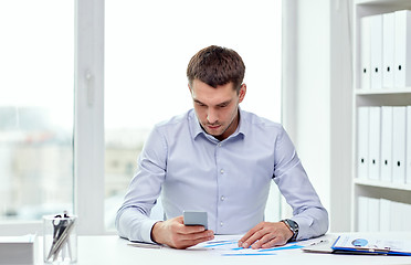 Image showing close up of businessman with smartphone