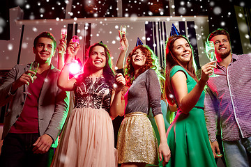 Image showing smiling friends with glasses of champagne in club