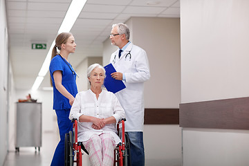 Image showing medics and senior woman in wheelchair at hospital