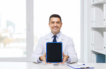 Image showing smiling male doctor showing tablet pc blank screen