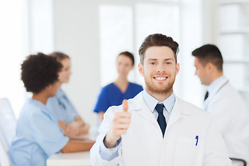 Image showing happy doctor over group of medics at hospital