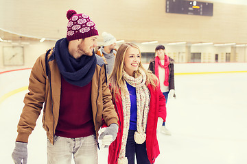 Image showing happy friends on skating rink