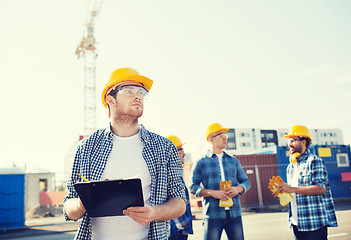 Image showing group of builders in hardhats outdoors