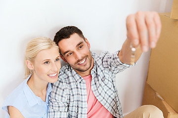 Image showing couple with key and boxes moving to new home