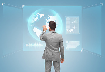 Image showing businessman touching virtual screen with globe