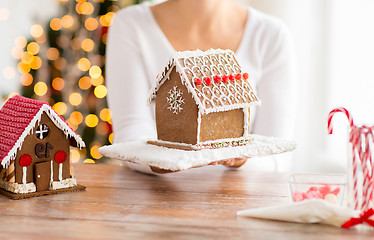 Image showing close up of woman showing gingerbread house