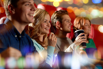 Image showing happy friends watching movie in theater