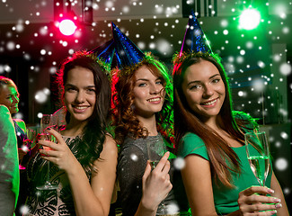 Image showing smiling friends with glasses of champagne in club