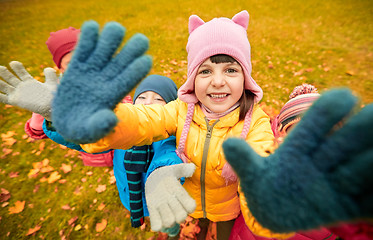 Image showing happy children waving hands in autumn park