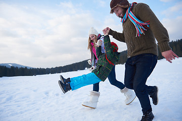 Image showing happy family playing together in snow at winter