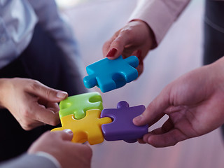 Image showing business people group assembling jigsaw puzzle