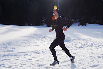 Image showing jogging on snow in forest