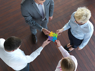 Image showing business people group assembling jigsaw puzzle