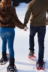 Image showing couple having fun and walking in snow shoes