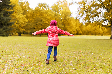 Image showing happy little girl having fun in autumn park