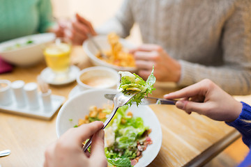 Image showing close up friends having dinner at restaurant