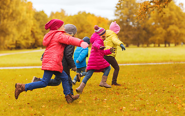 Image showing group of happy little kids running outdoors