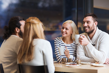 Image showing happy friends meeting and drinking tea or coffee