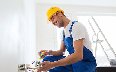 Image showing builder with tablet pc and equipment indoors