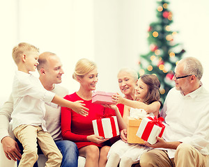 Image showing smiling family with gifts