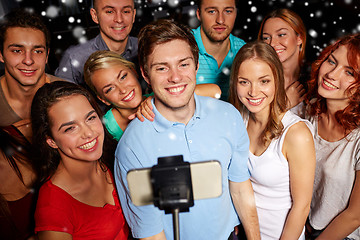 Image showing friends with smartphone taking selfie in club